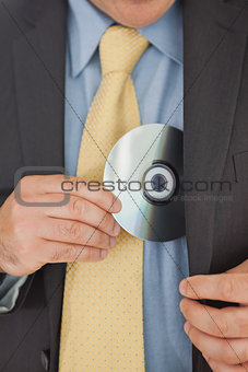 Businessman putting CD in his pocket