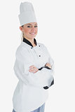 Happy female chef with arms crossed