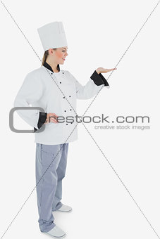 Female chef looking at invisible product