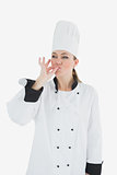 Female chef kissing her fingers