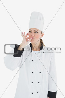 Female chef kissing her fingers