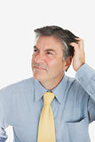 Confused businessman scratching head