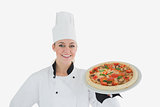 Happy female chef holding pizza