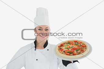 Happy female chef holding pizza