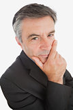 Thoughtful businessman with hand on chin