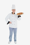 Confident female chef holding pizza