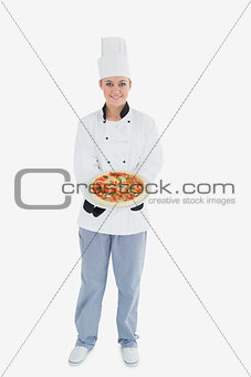 Female chef offering pizza