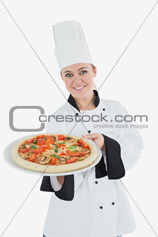 Happy female chef with pizza