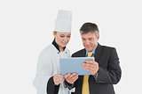 Businessman and female chef using digital tablet