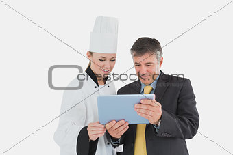 Businessman and female chef using digital tablet