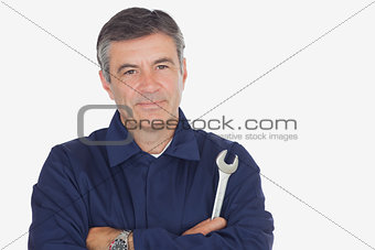 Confident male mechanic with wrench