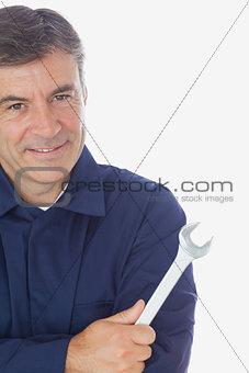 Happy mechanic holding wrench