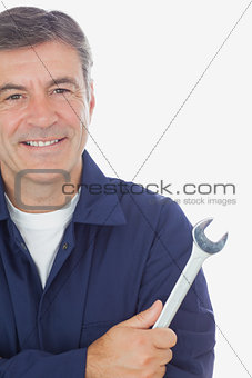 Male mechanic holding wrench