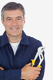 Mechanic with arms crossed holding pliers