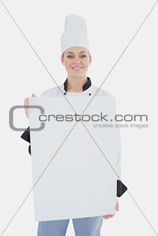Female chef with blank billboard