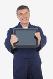 Mature mechanic showing digital tablet