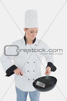 Chef holding frying pan and spatula