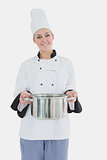 Female chef holding steel container