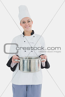 Female chef holding steel container