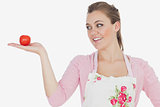 Woman looking at tomato