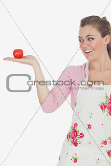 Young woman looking tomato