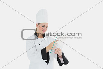 Female chef using glass tablet