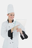 Female chef with glass tablet