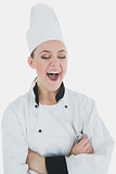 Chef holding wire whisk as she laughs