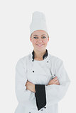 Confident female chef holding wire whisk