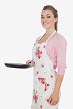 Woman in apron holding frying pan