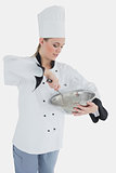 Chef holding wire whisk and mixing bowl