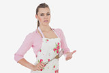 Serious woman in apron holding spatula