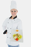 Confident chef with plate of healthy food
