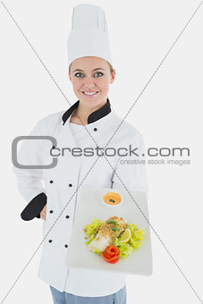 Confident chef with plate of healthy food