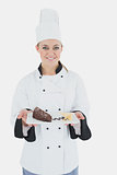 Female chef holding pastry plate