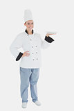 Portrait of female chef holding an empty plate