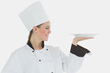 Female chef looking at an empty plate