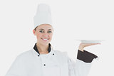 Confident chef holding an empty plate