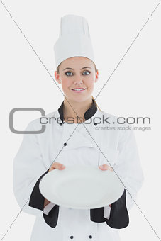 Female chef showing an empty plate