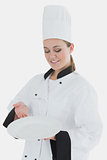Chef in uniform with an empty plate
