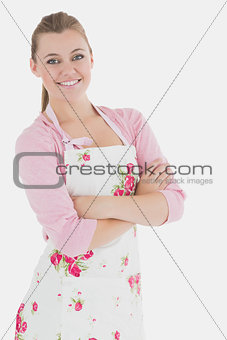Woman in apron standing with arms crossed