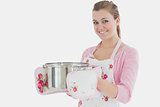 Young maid holding cooking utensil