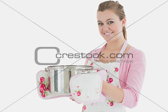 Young maid holding cooking utensil