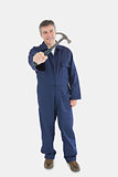Male technician holding hammer