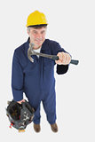 Mechanic with hammer carrying tool bag