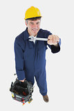 Mature mechanic with spanner carrying tool bag
