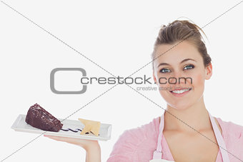 Happy young woman with plate of pastry