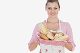 Maid holding basket full of breads