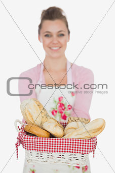 Happy young woman with bread basket