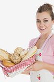 Happy young maid holding bread basket